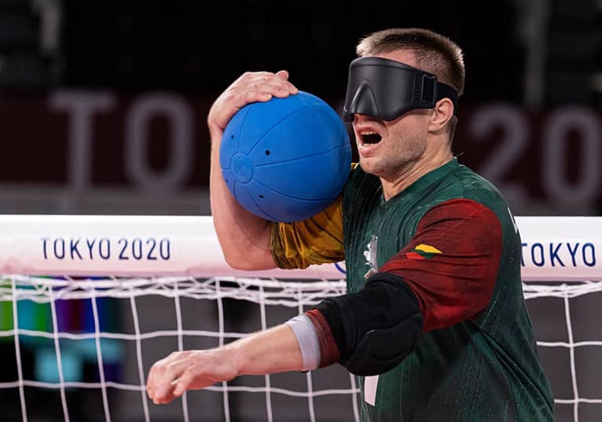 Goalball player Genrik Pavliukianec calling out while holding the ball